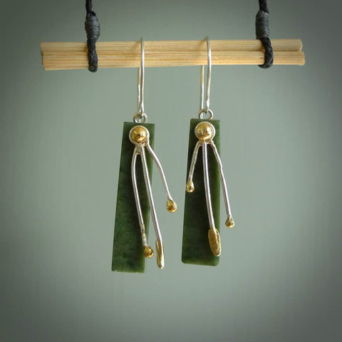 These kowhai flower drop earrings are beautifully hand made with gorgeous flair. They are fashionable and perfect for a women with style. Hand carved from a gorgeous piece of New Zealand Marsden jade with Gold leaf coating and sterling silver hooks - they are elegant and beautiful.