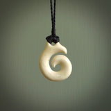 Natural cow bone hook with koru pendant. Hand carved by Yuri Terenyi in New Zealand. Maori design pendant for sale online. One only natural bone hook with koru necklace. Free delivery worldwide.