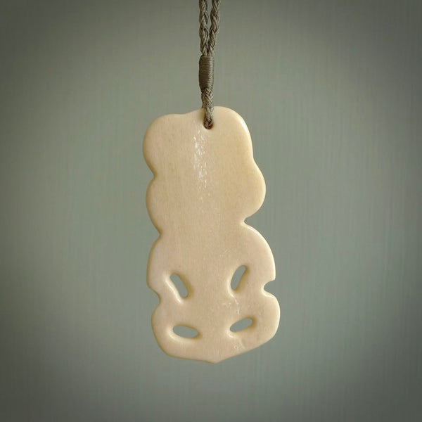 Hand carved bone Tiki pendant. Traditional art hand carved for NZ Pacific by Yuri Terenyi. Bone Tiki necklace with Paua Shell eyes.