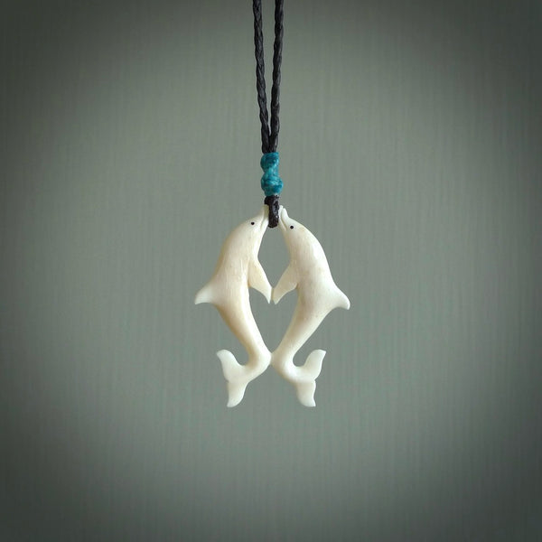 Hand carved natural double dolphin bone pendant. Hand made bone dolphin necklace, delivered with Express Courier. Hand crafted bone double dolphin pendant. One only necklace.