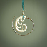 Hand carved pendants made from bone with sterling silver. NZ Pacific contemporary Koru pendants for sale online.