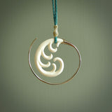 Hand carved pendants made from bone with sterling silver. NZ Pacific contemporary Koru pendants for sale online.