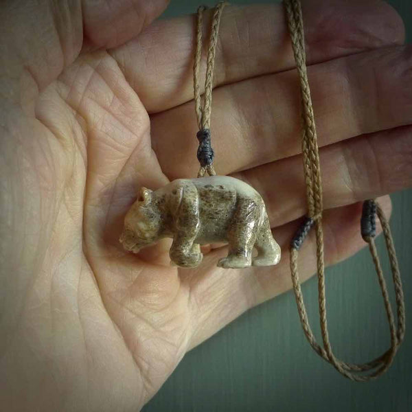 This picture shows a pendant that we designed in Woolly Mammoth Tusk. It is a little Panda bear that has a walking stance and is carved in detail. A really attractive and eye-catching piece of handmade jewellery. The cord is hand plaited braid in kalahari and the length can be adjusted.