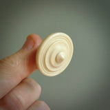 A traditional hand carved bone spinning top toy. This piece is made from bone and is a fully functioning toy that can be played with. Beautiful, contemporary art hand made by NZ Pacific.