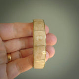 This piece is a hand made bracelet. It is made from selected pieces of woolly mammoth tusk which we have cut and polished and then inset into a brass bracelet. It is a very striking piece one of a kind and truly beautiful.
