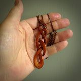 A one off beautiful piece of carved art. We have called this Wrap Around, it was hand carved for us by Yuri Terenyi and is a manaia with twist design pendant. This is a wonderful ethnic bone pendant designed to be worn. It has been stained by a homemade tea dye in a bright gingery brown colour and we have hand plaited an adjustable cord in wapiti and ginger nut colours.