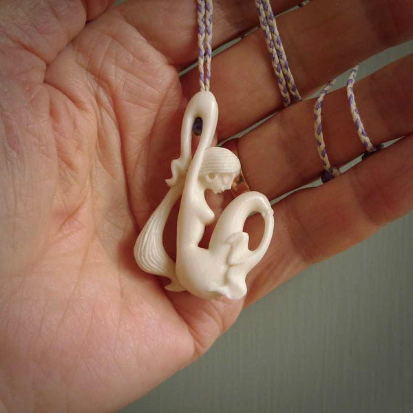 This pendant is a gorgeous and intricately carved mermaid pendant. Carved by renowned bone carver Yuri Terenyi for us. This is a little masterpiece. It is a mermaid with her arms clasped around her tail. The craftsmanship displayed in this piece is extraordinary - a collectors item, or a piece to wear and love.