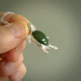 New Zealand Jade stone turtle in Sterling silver engraved casing. Hand carved jewellery made by NZ Pacific and for sale online. Moana, Ocean, jewellery hand carved in fire agate and Sterling Silver turtle necklace.