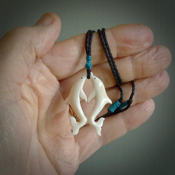 Hand carved natural double dolphin bone pendant. Hand made bone dolphin necklace, delivered with Express Courier. Hand crafted bone double dolphin pendant. One only necklace.