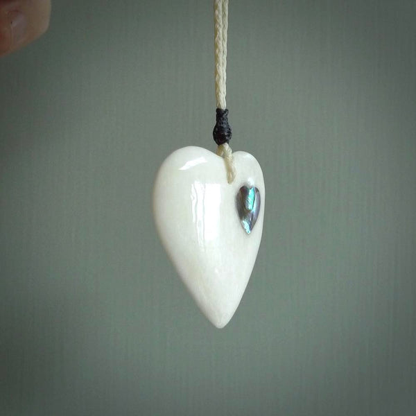 HAND CARVED HEART PENDANT. CARVED FROM BONE. PAUA HEART INSERT. HAND MADE BY NZ PACIFIC. HANDMADE JEWELLERY FOR SALE ONLINE.