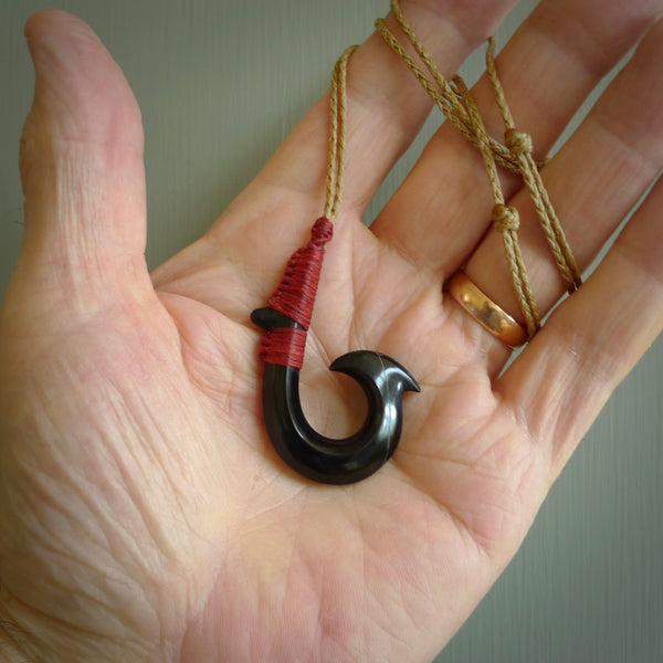 These pendants are hand carved, black jade Hawaiian hooks or Makau pendants. They are beautifully finished in a high polish and bound with a deep Pohutukawa red cord and a Kalahari tan necklace. Hand made jewellery that make the most wonderful gifts. Free shipping worldwide.