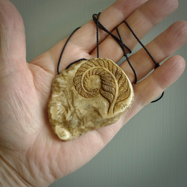 A hand carved kiwi skeleton pendant carved from a piece of deer antler crown. This is a work of art carved by Fumio Noguchi who is renowned for his skill in bone carving. The kiwi is a native bird to New Zealand. This is a great piece representing this very cool bird.