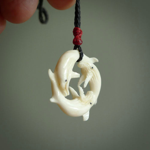 Hand carved natural bone whale trilogy pendant. Art to wear. Ocean themed pendants.