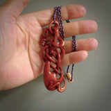 A one off beautiful piece of carved art. Hand carved for us by Yuri Terenyi and is an intricate and complex twist with manaia pendant. This is a wonderful ethnic bone pendant designed to be worn. It has been stained by a homemade tea dye in a bright gingery brown colour and we have hand plaited an adjustable cord in brown and lilac with a lilac floret popper.
