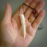 A mythical bird head hand carved from bone with Paua shell eyes. This is a one only bird head with long beak necklace hand made from natural bone with paua shell eyes. This bird head has engravings and is a magnificent piece of art to wear. It is delivered on a black adjustable cord.