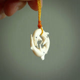 Hand carved natural bone whale trilogy pendant. Art to wear. Ocean themed pendants.