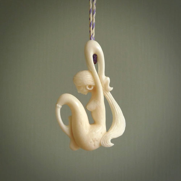 This pendant is a gorgeous and intricately carved mermaid pendant. Carved by renowned bone carver Yuri Terenyi for us. This is a little masterpiece. It is a mermaid with her arms clasped around her tail. The craftsmanship displayed in this piece is extraordinary - a collectors item, or a piece to wear and love.