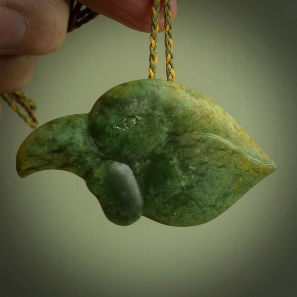 This picture shows a flower jade birds head. The bird is an extinct kokako - a saddleback that used to line in New Zealand's South Island. The cord is plaited and length adjustable. It is in two colours - khaki and burnt gold. We ship this worldwide.