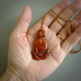 Hand carved stained bone meditating male figure pendant. Made from natural bone. Bone jewellery from the Pacific for sale online. Male pendant for men and women.