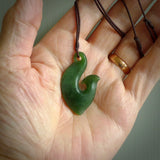 This matau is carved from a very striking New Zealand  jade. It is both intricate and simple in design - it has hidden folds and smooth curves. A piece to be worn or displayed - the carving and the jade are both magnificent. One only jade hook necklace hand made by Ric Moor.