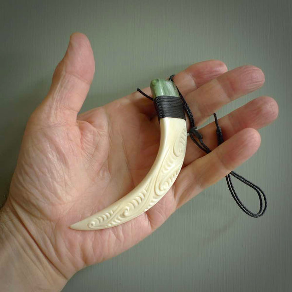 Boars Tusk Pendant with a jade cap. Hand made pendant carved from a boars tusk. Hand made ethnic or maori jewellery for sale by NZ Pacific online.