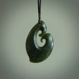 A hand carved large sized contemporary kour pendant. This is a piece of genuine jade jewellery, hand carved by Ric Moor. He has used New Zealand jade and has utilised his experience and carving skill to highlight the natural beauty of the stone. Delivered worldwide, postage is included in the price.