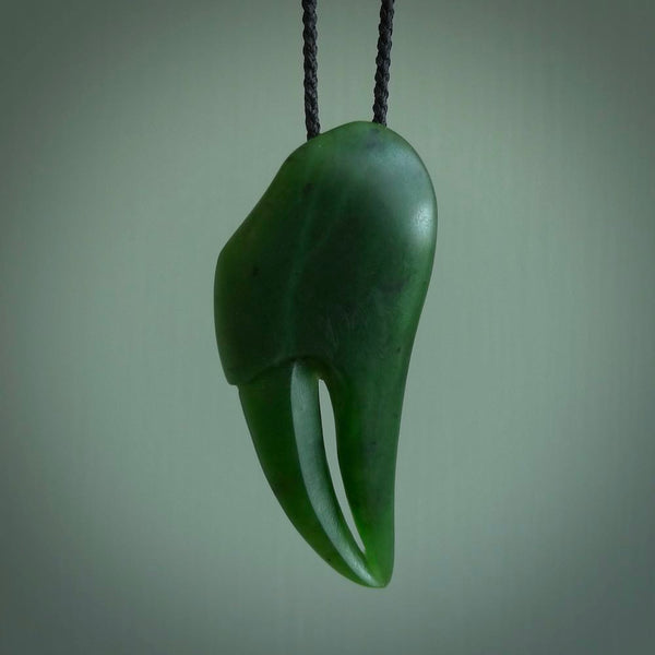 This large crab claw pendant is carved from a lovely deep green piece of New Zealand jade. It has an adjustable black coloured cord which can be slipped over the head and adjusted to the length that you prefer. Hand carved in New Zealand from our local jade by Kyohei Noguchi.