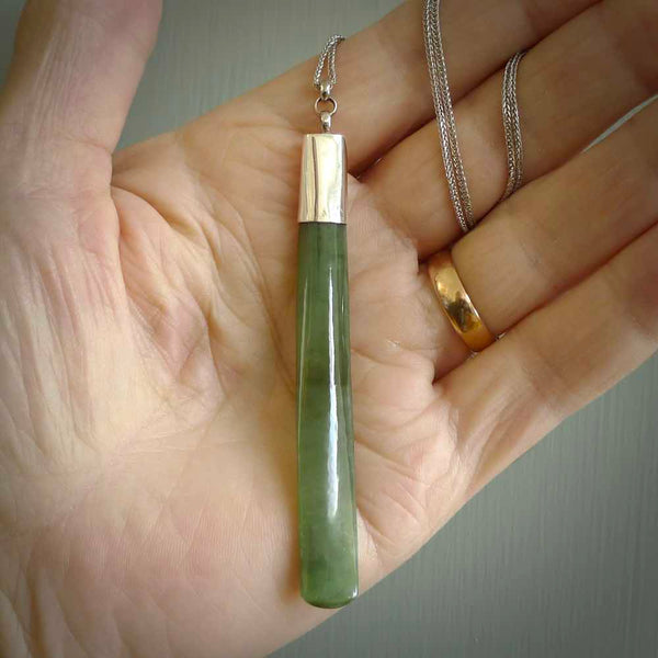 This picture shows two beautiful large sized drop pendants carved in New Zealand Jade, pounamu with sterling silver cap. It is a lovely semi-translucent green colour, which is glows when held to the light. A gorgeous and very meaningful pendant with an sterling silver chain.