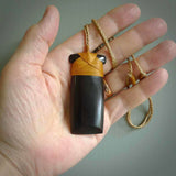 This photo shows wooden toki pendants. The cord is length adjustable which allows the pendant to be positioned where it suits you best. The toki was carved for us in hard wood. Unique art to wear.