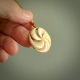 Hand carved koru style pendant. Made from Woolly Mammoth Tusk.