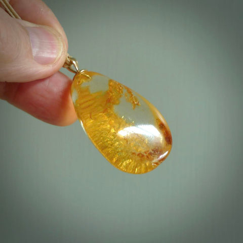 A beautiful, medium-large sized pendant handmade from Amber by Sami. This material is around 100 million years old and makes a lovely light and rare piece of jewellery. Hand carved Amber drop pendant.
