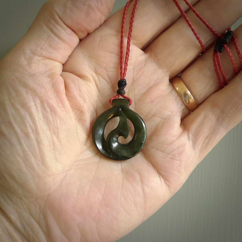 Jade matau or hook pendant. Carved from New Zealand pounamu in New Zealand. Hand carved jade jewellery for sale online.