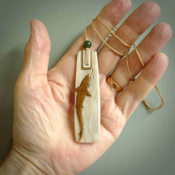 Hand carved Whale Bone Toki by Alex Sands Studio. One only New Zealand whale bone toki with shark engraving necklace for men and women. Unique New Zealand art to wear. Shipped to you on an adjustable cord. 