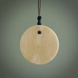 This piece is a hand carved contemporary bone shield pendant. Yuri Terenyi has carved this from Bone. It is a delightful, artistic piece of jewellery. One only necklace.