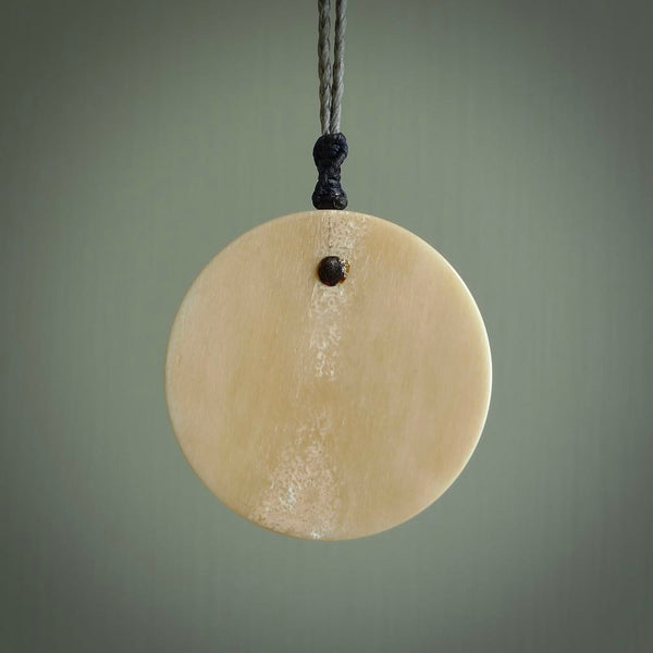 This piece is a hand carved contemporary bone shield pendant. Yuri Terenyi has carved this from Bone. It is a delightful, artistic piece of jewellery. One only necklace.