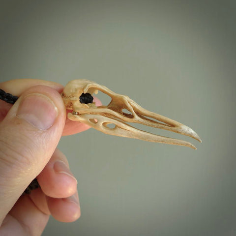 This is a hand carved deer antler huia bird skull pendant. It is made from deer antler, bone. This is a large sized necklace and is a very unique, one only, pendant that is a collectors piece. Hand carved deer antler huia skull necklace for men and women.