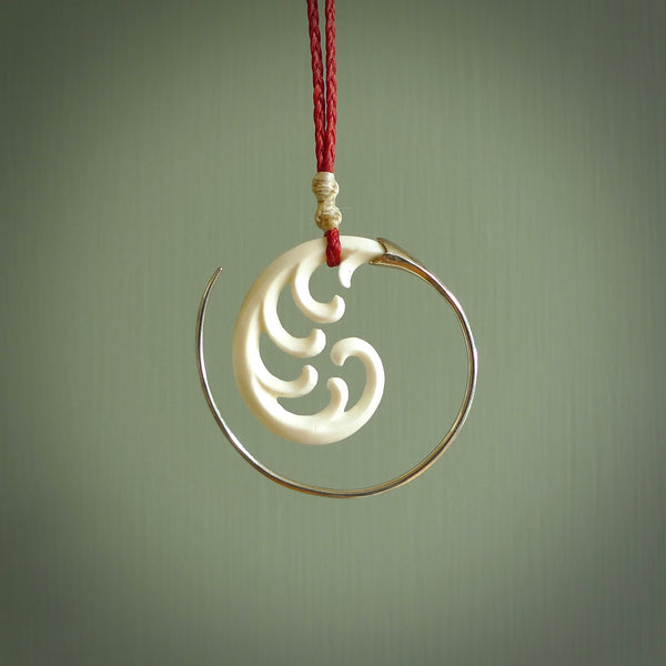 Hand carved pendants made from bone with sterling silver. NZ Pacific contemporary Koru pendants for sale online.