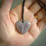 A hand carved heart pendant made from New Zealand Rhodonite Stone. This is a medium sized and visually striking piece, beautifully curved and sensuous. The perfect piece of jewellery for someone you love.