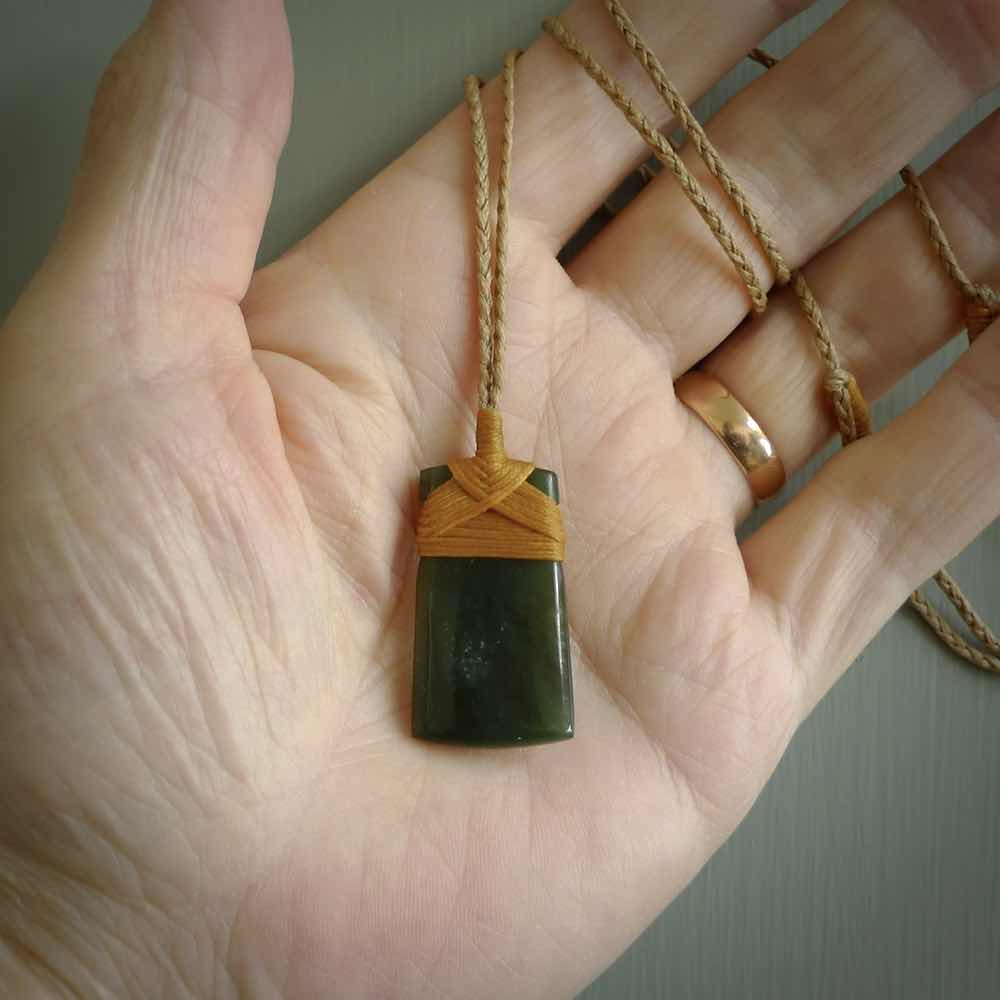Unique small Jade Toki hand carved here in New Zealand, the cord is adjustable.
