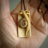 A hand carved bamboo with snail pendant carved from a piece of deer antler. This is a work of art carved by Fumio Noguchi who is renowned for his skill in bone carving. This is a great piece representing this very cool plant and animal.