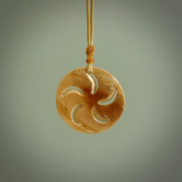 Hand carved koru style pendant. Made from Woolly Mammoth Tusk.