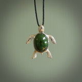 New Zealand Jade stone turtle in Sterling silver engraved casing. Hand carved jewellery made by NZ Pacific and for sale online. Moana, Ocean, jewellery hand carved in fire agate and Sterling Silver turtle necklace.