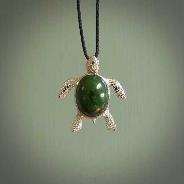 New Zealand Jade stone turtle in Sterling silver engraved casing. Hand carved jewellery made by NZ Pacific and for sale online. Moana, Ocean, jewellery hand carved in fire agate and Sterling Silver turtle necklace.