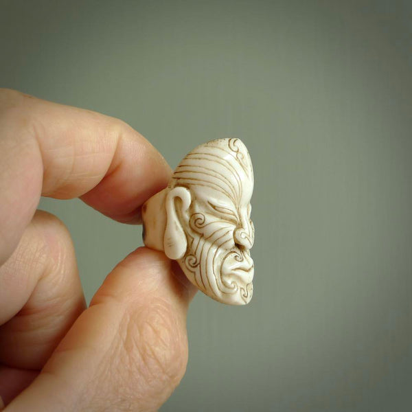 Hand carved Moko man face ring. Made from Red Deer antler in New Zealand. Unique Moko Man ring hand made from deer antler by master bone carver Fumio Noguchi. Spectacular collectable work of art, made to wear. One only ring, delivered to you at no extra cost with express courier.