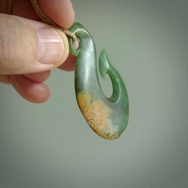 Hand carved flower jade matau pendant. Hand made in New Zealand by Ric Moor. Unique and authentic jade jewellery for sale online. Jewellery hand made by NZ Pacific. Carved by NZ Pacific.