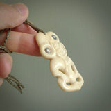 Hand carved bone Tiki pendant. Traditional art hand carved for NZ Pacific by Yuri Terenyi. Bone Tiki necklace with Paua Shell eyes.