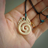 This is a unique manaia with koru, hand carved natural bone pendant with Paua Shell eyes. The cord is Black and is length adjustable. This is delivered to you with Express Courier. The eyes are made from Paua shell.