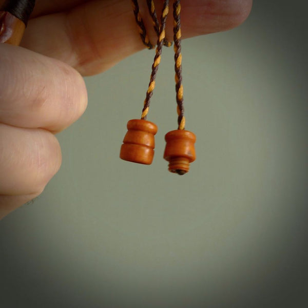 This necklace is carved from cow bone and stained with a homemade tea dye. It is a unique piece of wearable art that is sure to catch the eye. The shape is a complex twist form and has been beautifully hand carved by bone carver Yuri Terenyi.