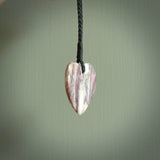 A hand carved heart pendant made from New Zealand Rhodonite Stone. This is a medium sized and visually striking piece, beautifully curved and sensuous. The perfect piece of jewellery for someone you love.
