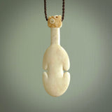 Hand carved engraved bone patu necklace hand made here in New Zealand. One only artistic patu pendant with hand plaited dark brown adjustable cord. Shipped to you with Express Courier. Stand out patu pendant for men and women. Bone patu with Paua shell insert eyes.